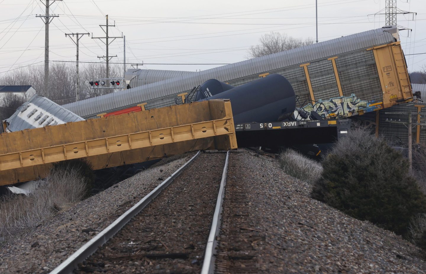 Multiple cars of a Norfolk Southern train lie toppled after derailing at a train crossing with Ohio 41 in Clark County, Ohio, March 4, 2023.