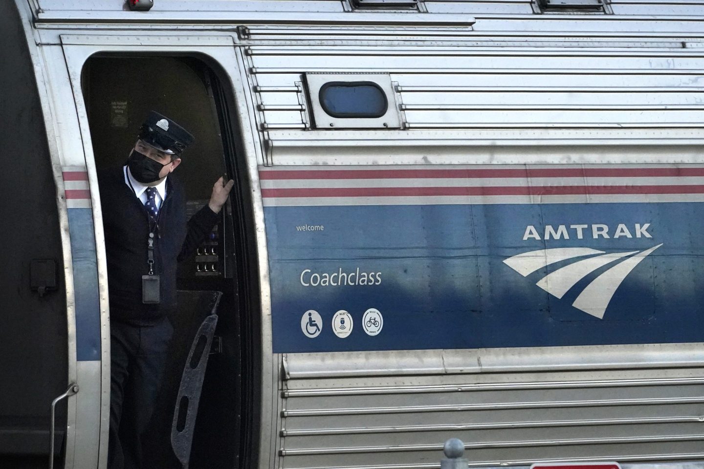 A conductor makes sure all is clear as the Amtrak Downeaster passenger train pulls out of the station, Dec. 14, 2021, in Freeport, Maine.