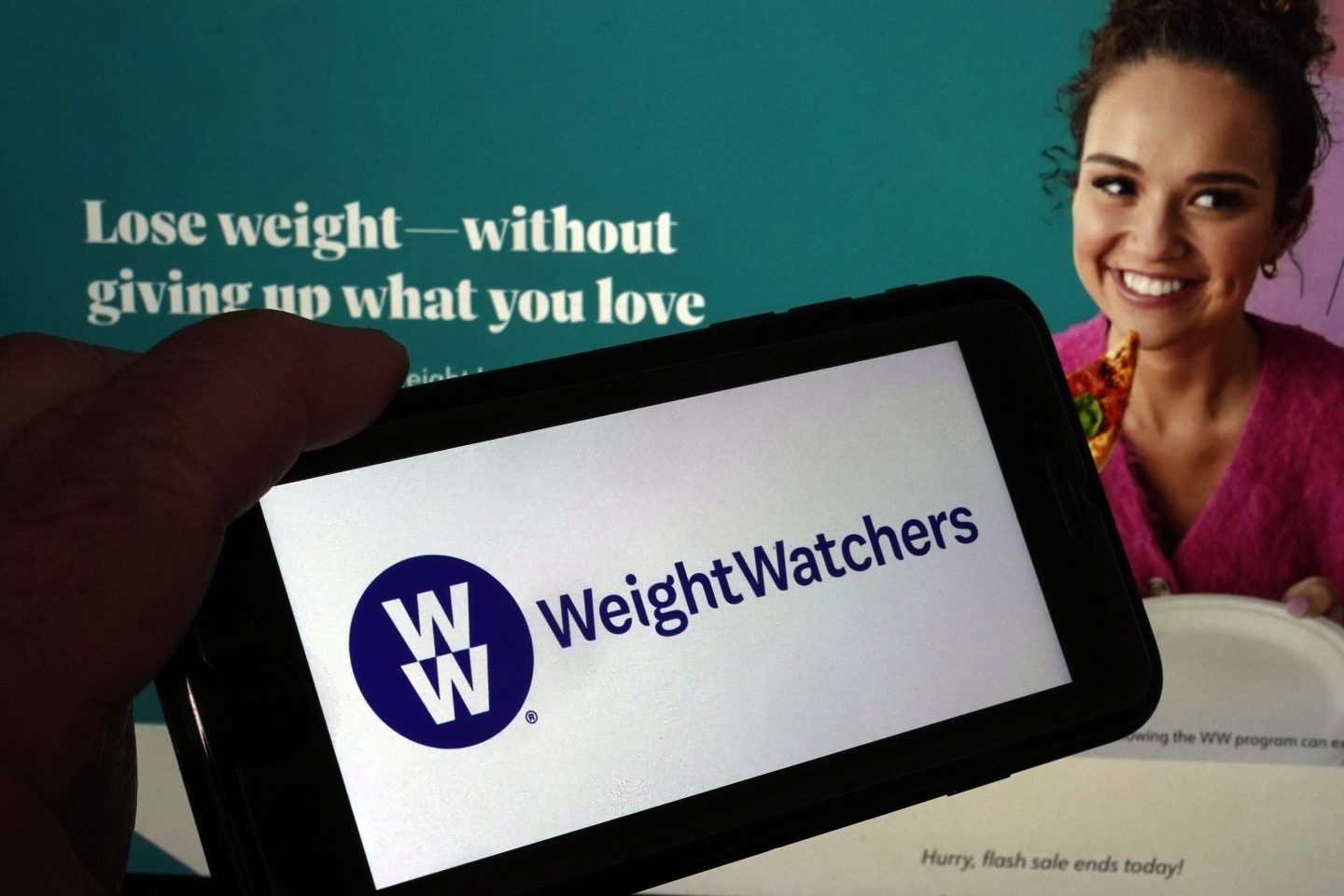 This image shows the logo of WeightWatchers on a mobile phone, and the company's website, in New York, Tuesday, March 7, 2023.