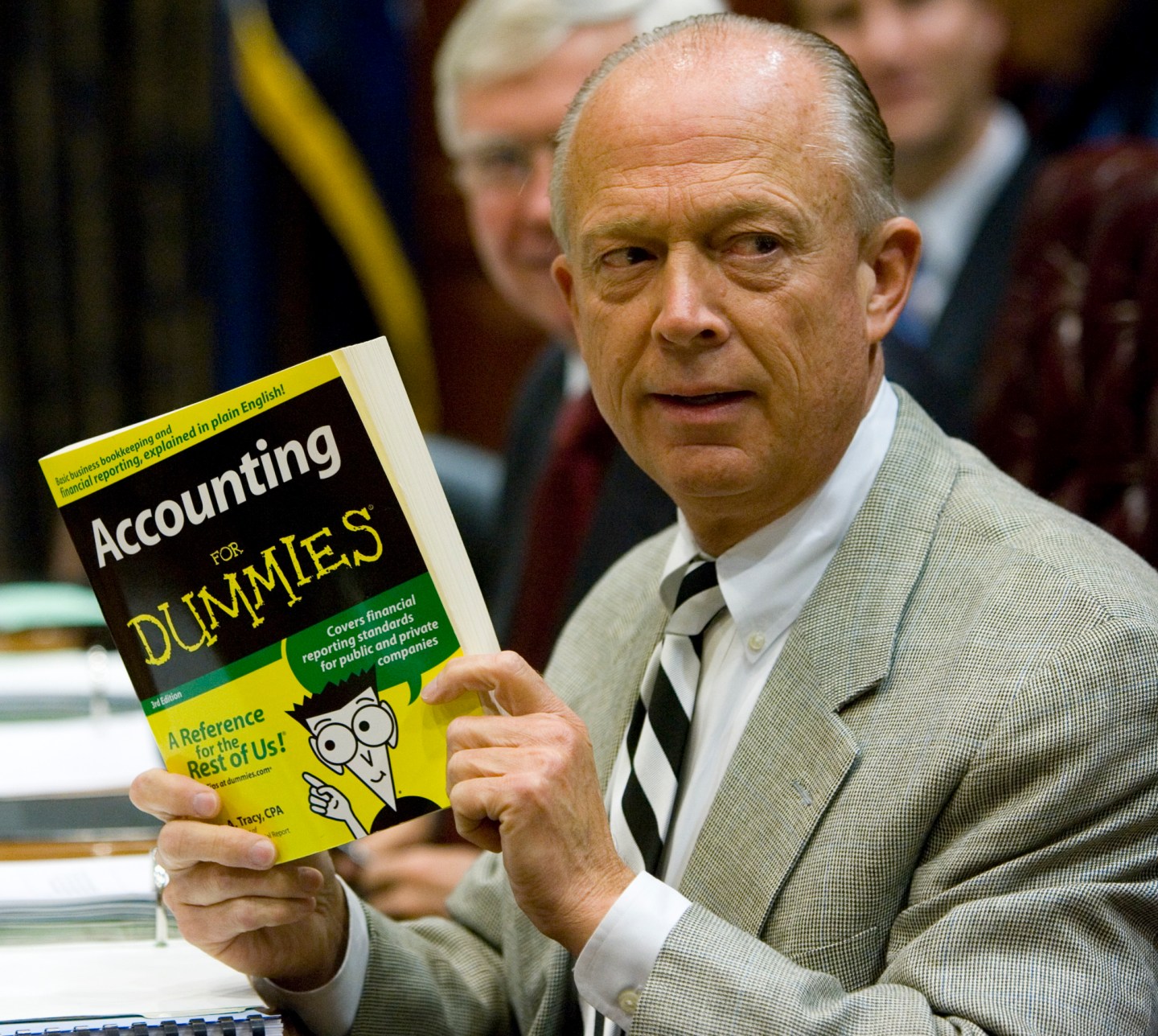 South Carolina Comptroller General Richard Eckstrom holds up a book he wanted to present to his new Chief of Staff James Holly during his introduction at the Budget and Control Board meeting, Aug. 13, 2009, in Columbia, S.C.
