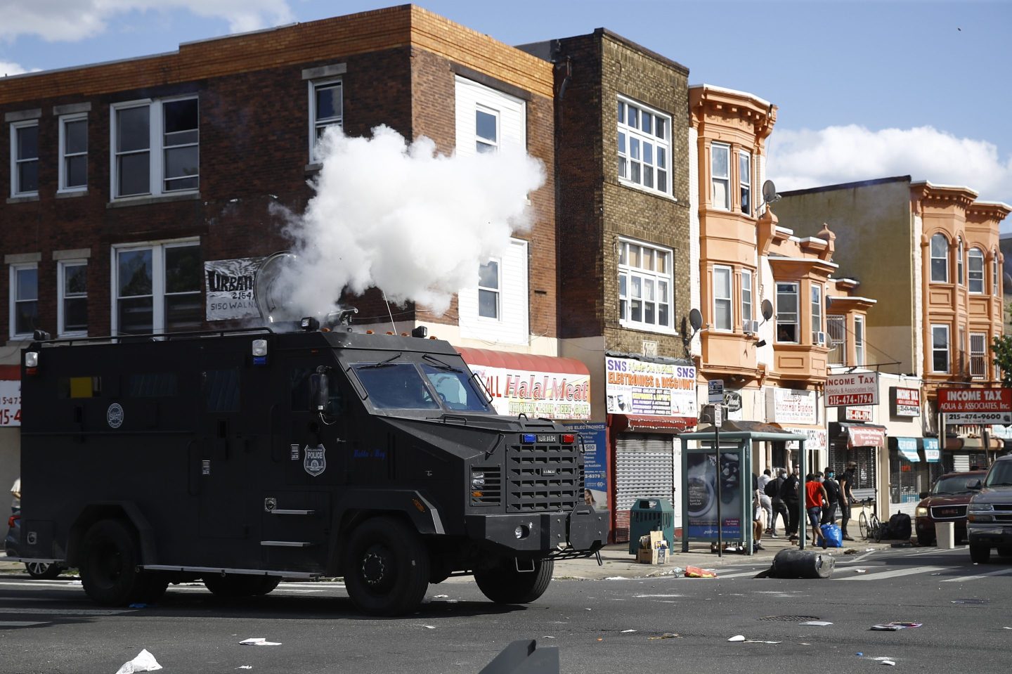 Police deploy tear gas to disperse a crowd during a protest on May 31, 2020, in Philadelphia over the death of George Floyd. Philadelphia officials announced a $9.25 million settlement Monday, March 20, 2023, with hundreds of people over several lawsuits challenging the police response to the protests and civil disorder in 2020 after George Floyd's death at the hands of Minneapolis police.