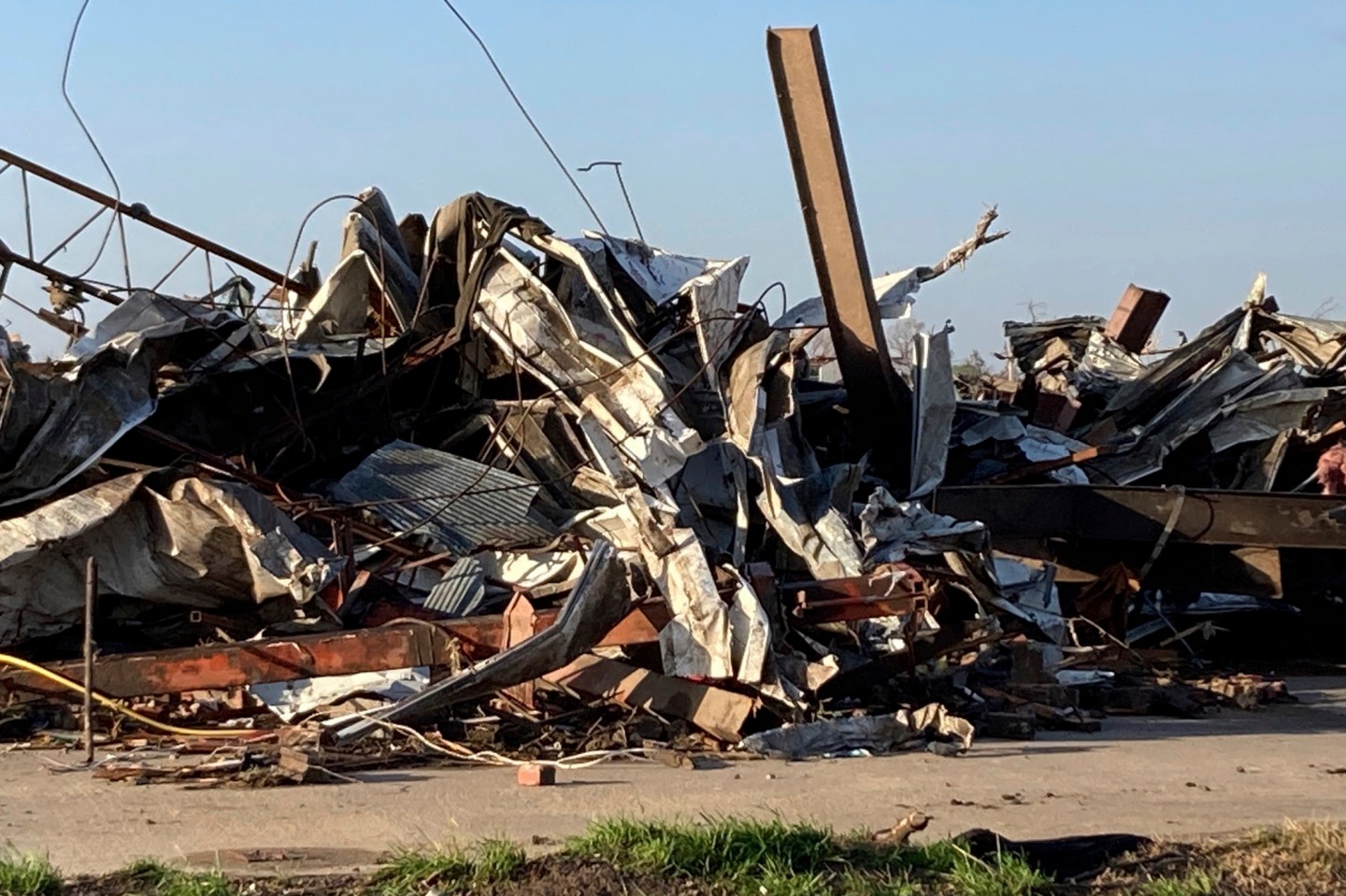 Debris covers a damaged structure in Rolling Fork, Miss,. on Saturday. Powerful tornadoes tore through the Deep South on Friday night.