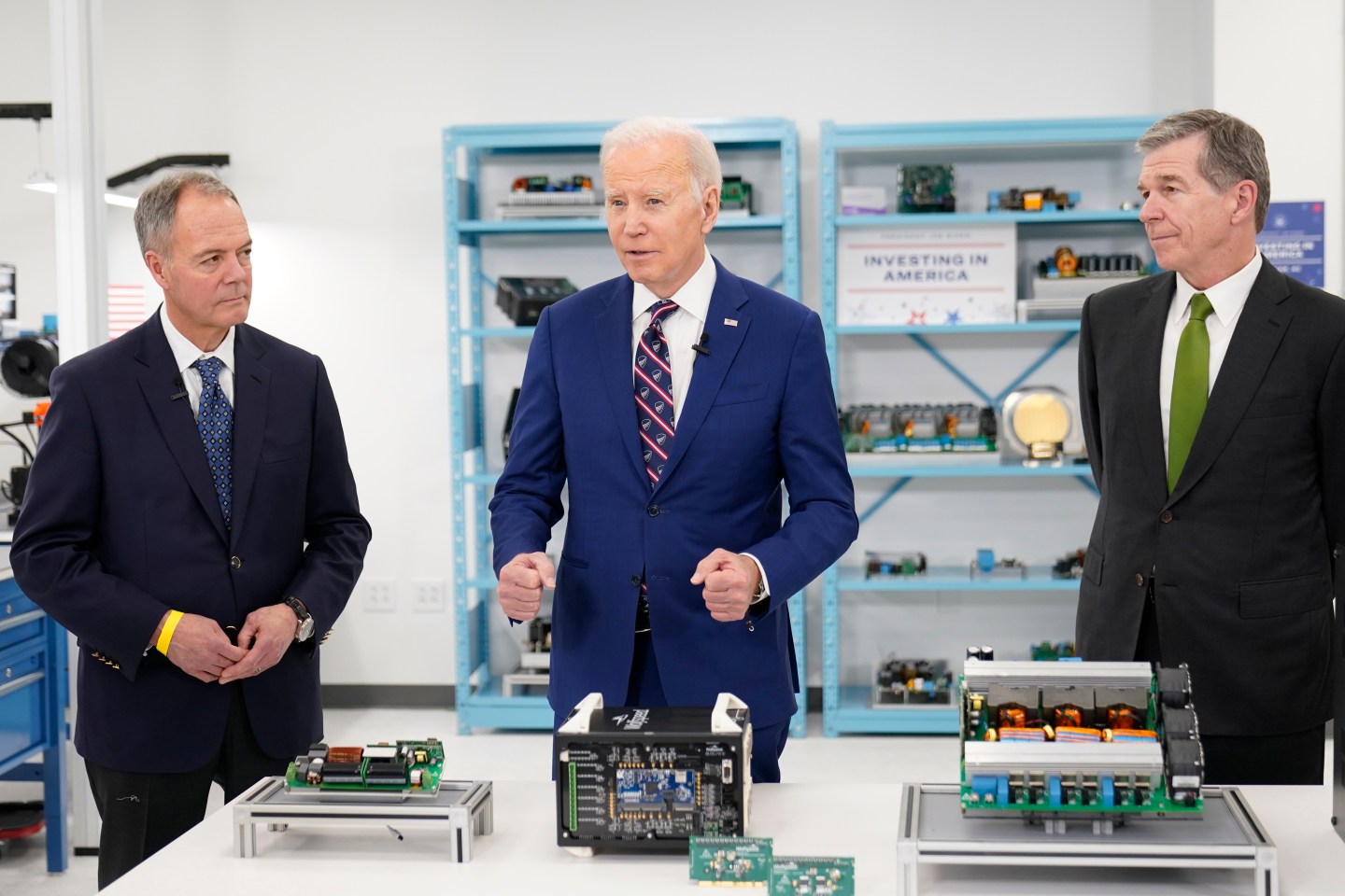 President Joe Biden tours semiconductor manufacturer Wolfspeed Inc., in Durham, N.C., Tuesday, March 28, 2023, with CEO Gregg Lowe and North Carolina Gov. Roy Cooper, right. (AP Photo/Carolyn Kaster)

