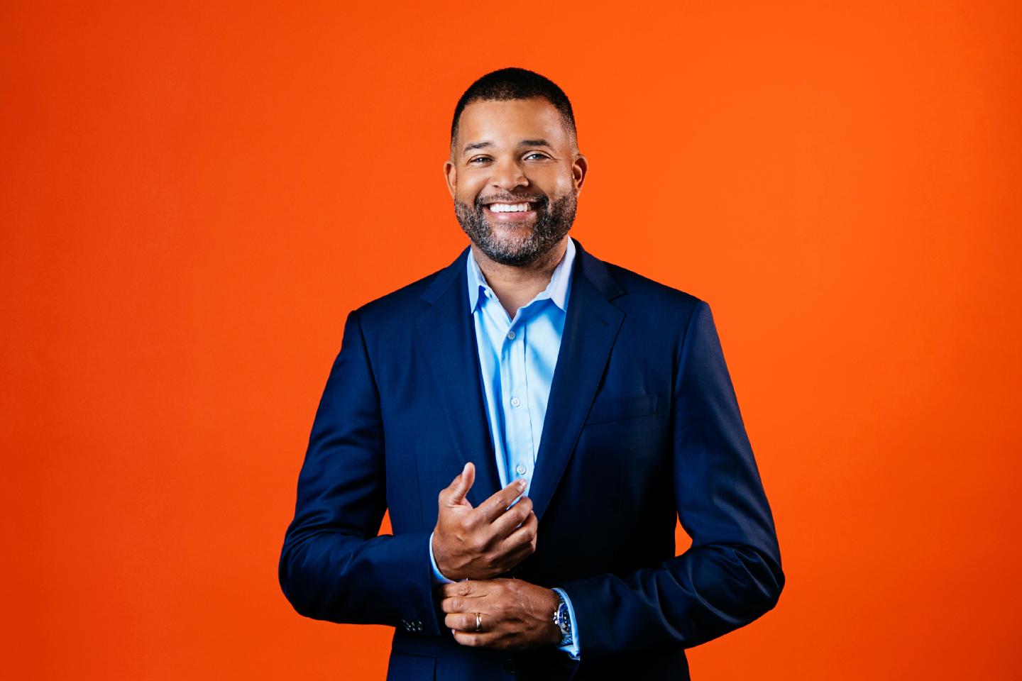 Portrait of Cruise CFO Bill Nash on orange background.
