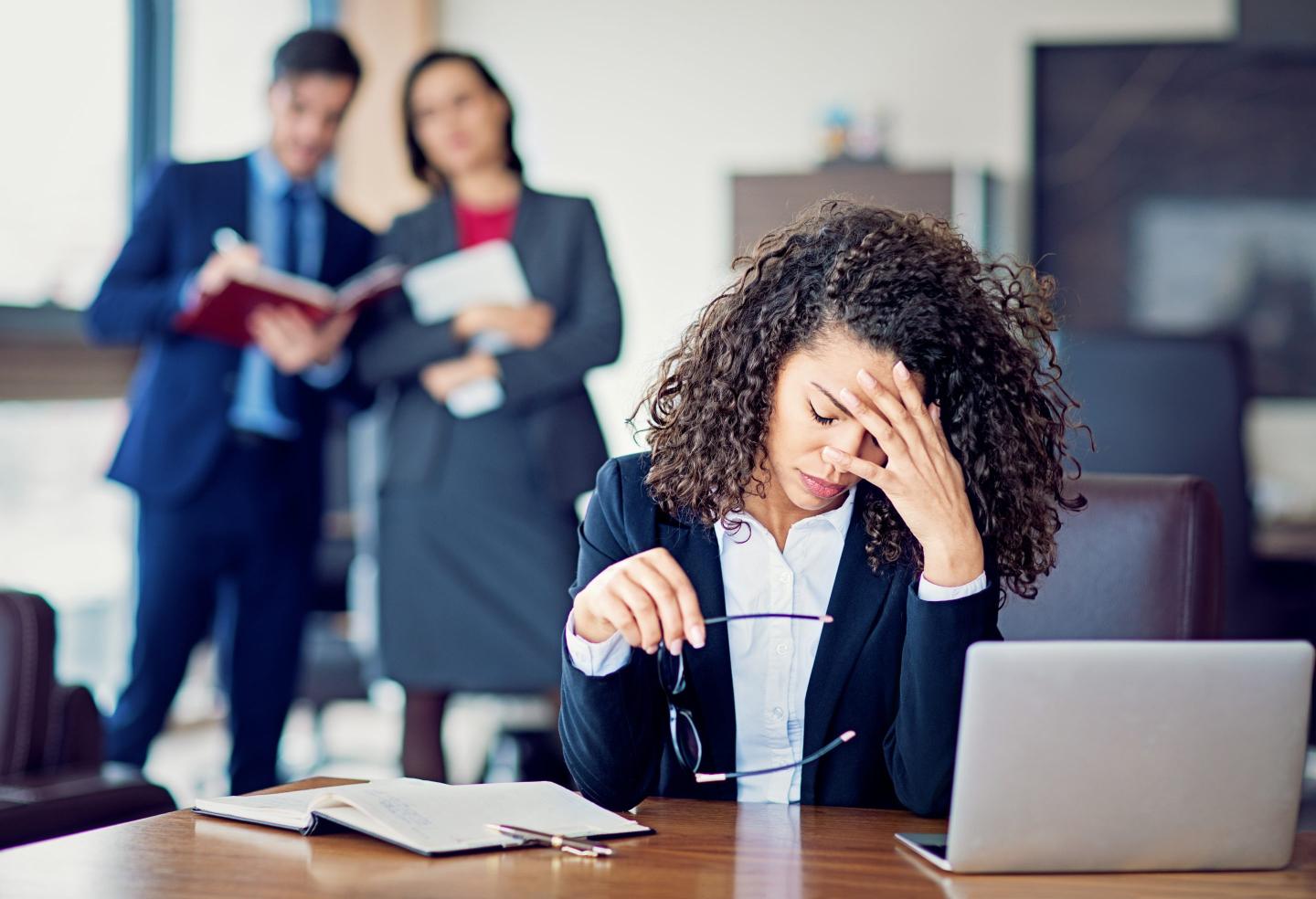 Businesswoman holding head in hands in the office