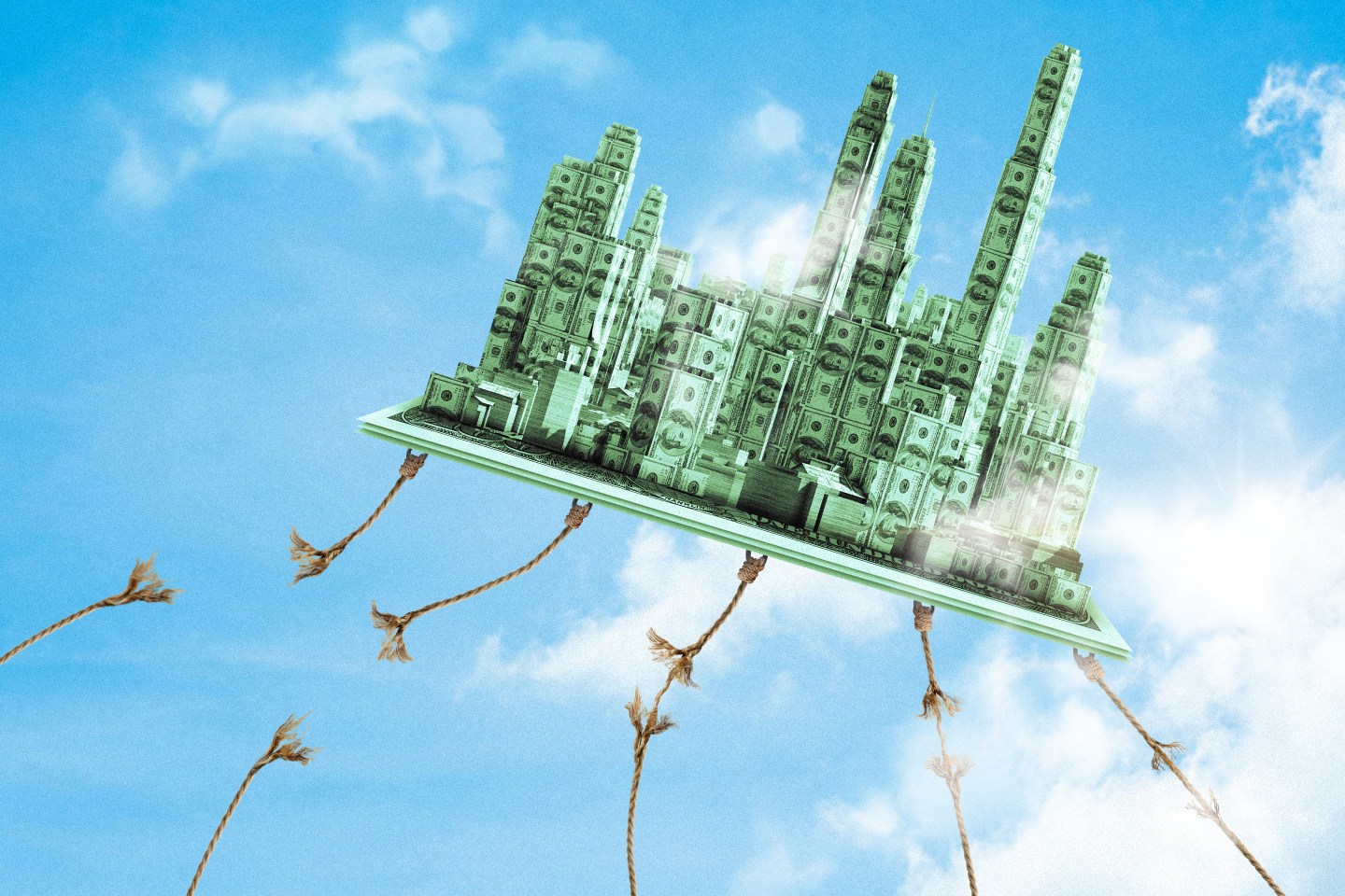Photo illustration of a cityscape in the sky made out of $100 bills coming loose from a series of ropes that are holding it down.