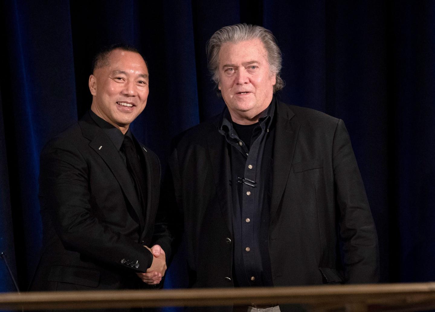 Former White House Chief Strategist Steve Bannon (R) greets fugitive Chinese billionaire Guo Wengui