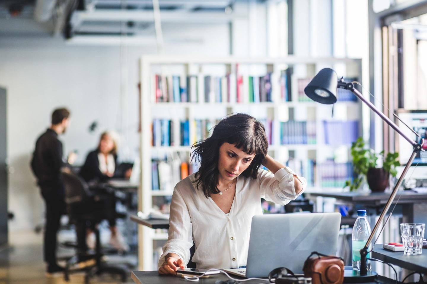 Businesswoman looking uneasy at her laptop