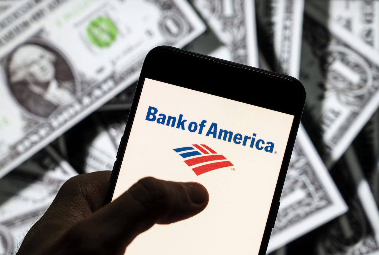 Bank of America logo seen on an Android mobile device screen with the currency of the United States in the background