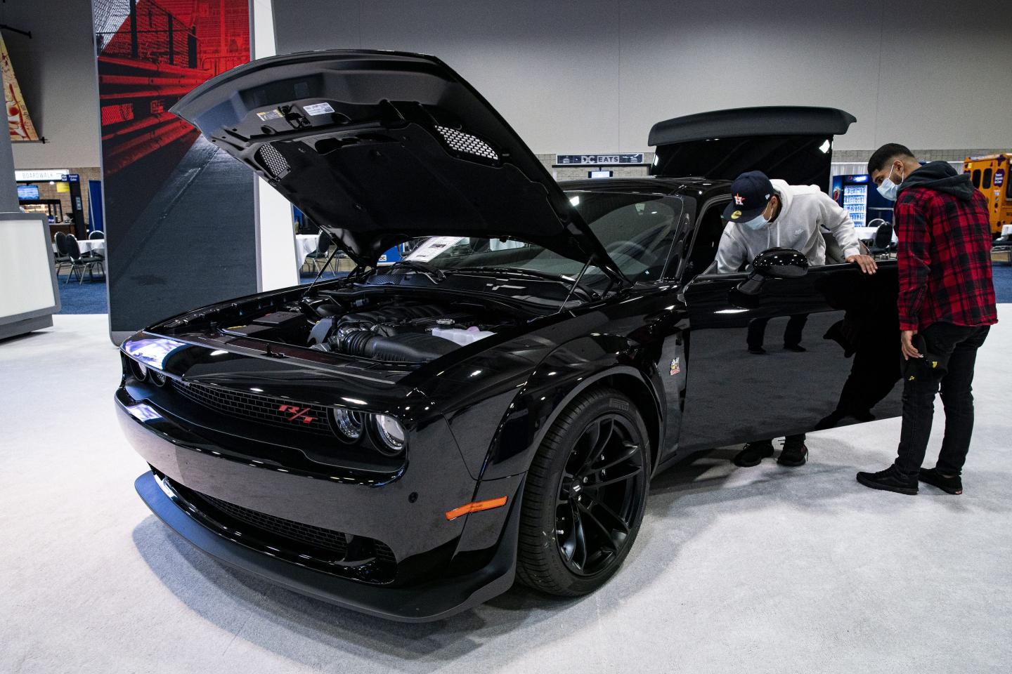 Attendees view a 2021 Dodge Challenger R/T Scat Pack Widebody during the Washington Auto Show in 2022