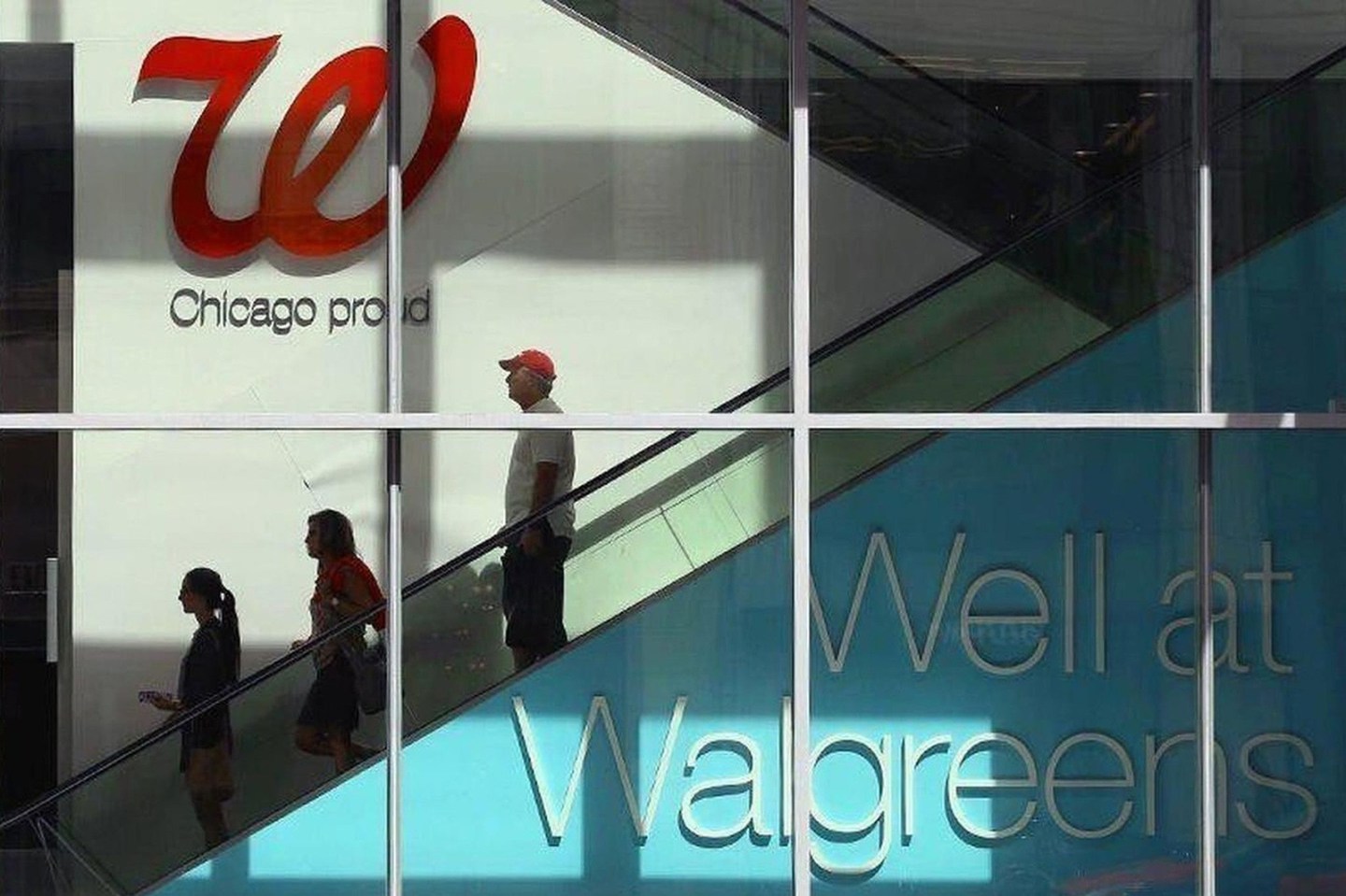 People ride an escalator at the Walgreens store.