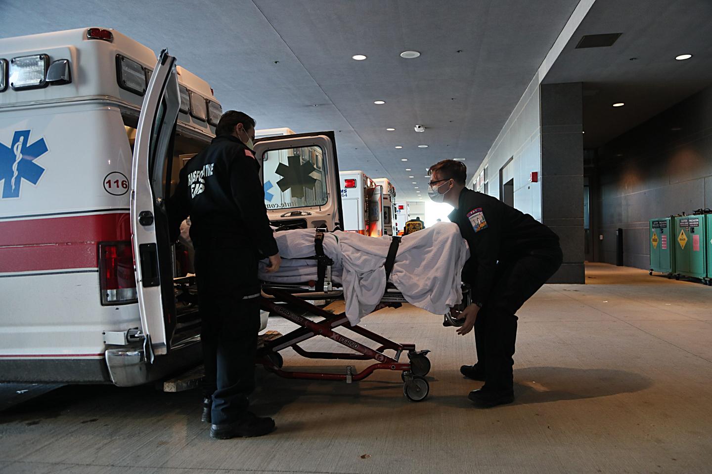 EMTs transfer a patient in the busy ambulance bay at UMass Memorial Medical Center.