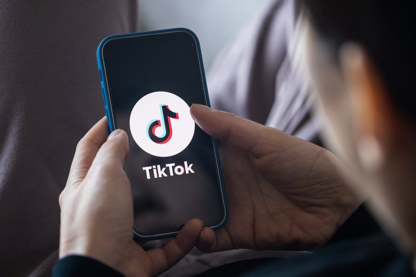 A person uses TikTok on a smartphone