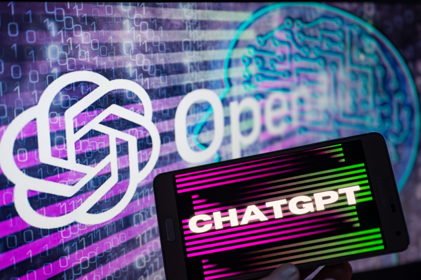 OpenAI logo seen on screen with ChatGPT website displayed on mobile seen in this illustration, on January 8, 2023 in Brussels, Belgium.