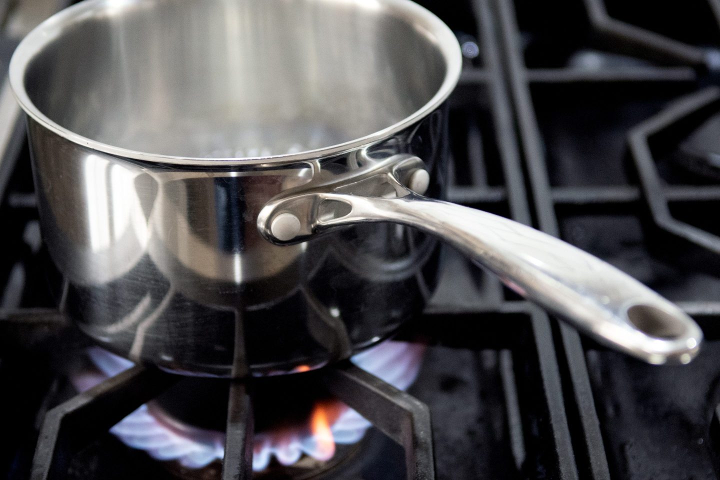 A pot sits on a natural gas burning stove.