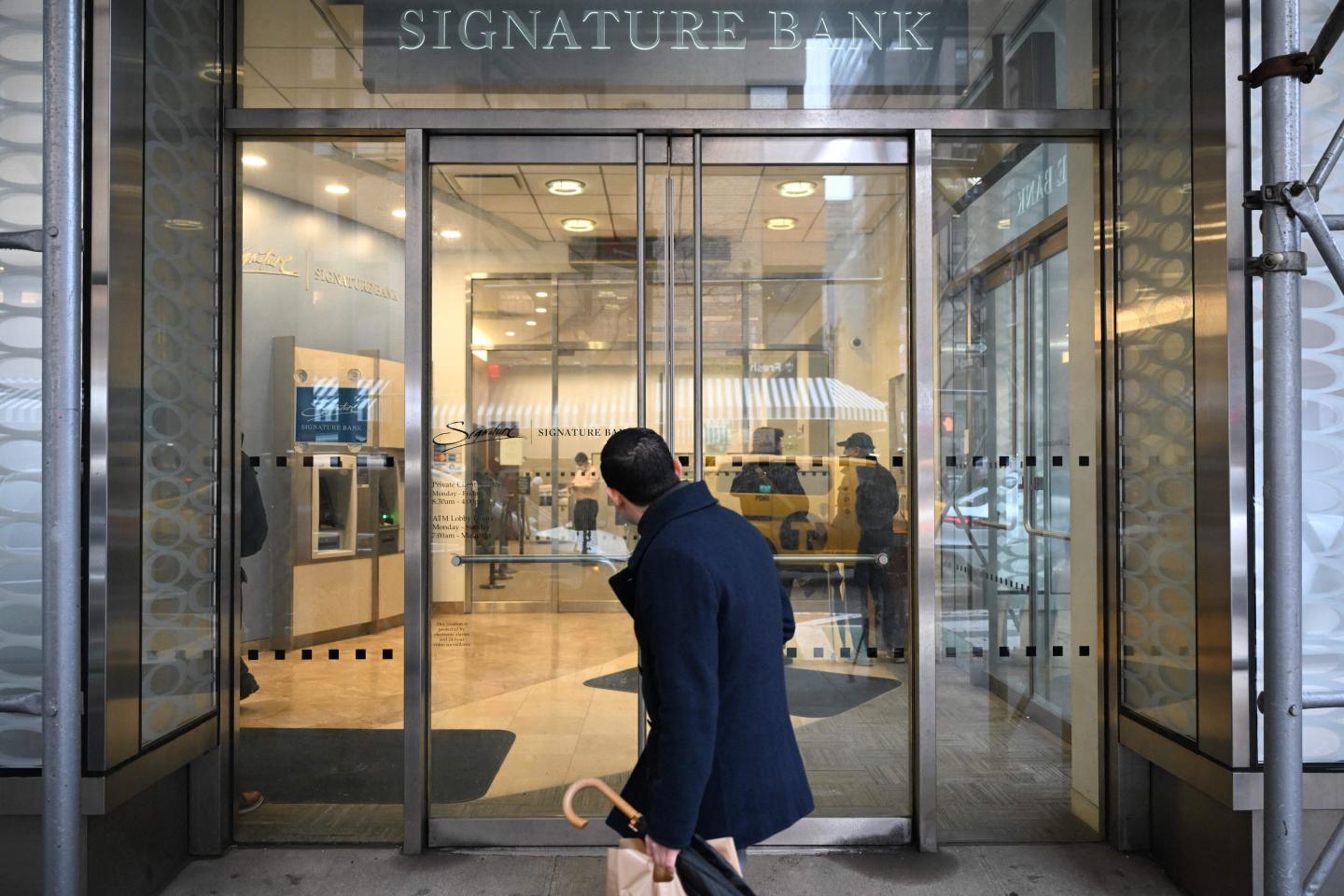 A man walks past a branch of Signature Bank in New York city on March 13, 2023.