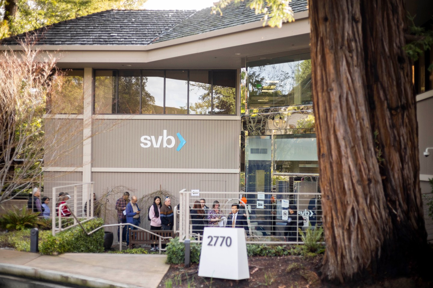 People wait for service outside Silicon Valley Bank in Menlo Park, Calif.