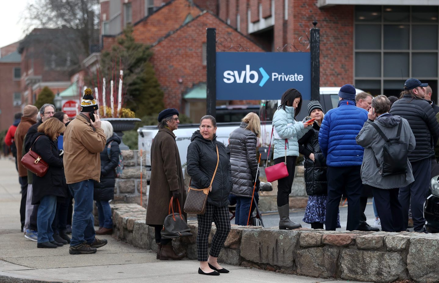 Bank customers line up outside Silicon Valley Bank on Monday following its collapse.