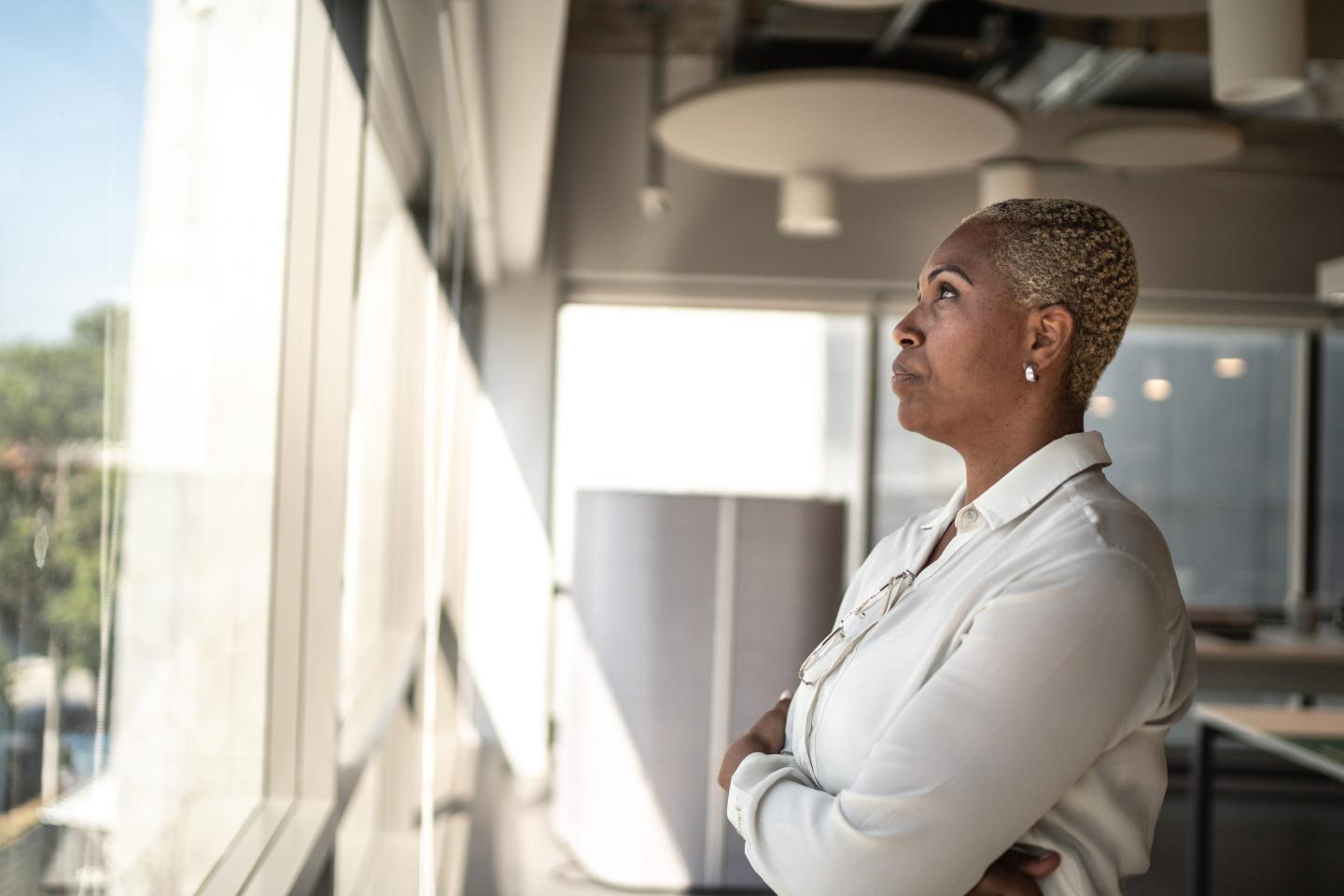 Serious businesswoman looking through the window