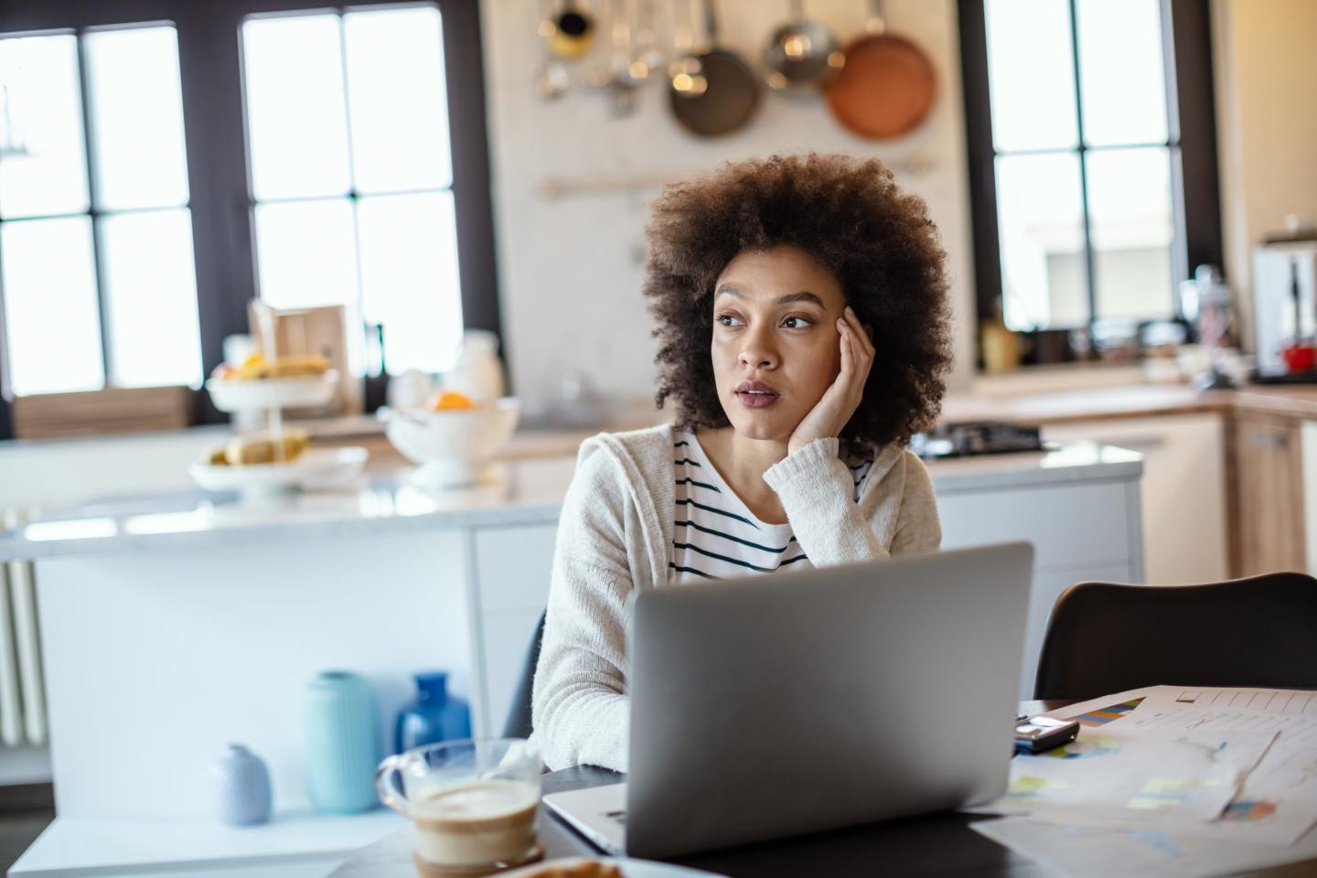 woman working from home and looking sombre.
