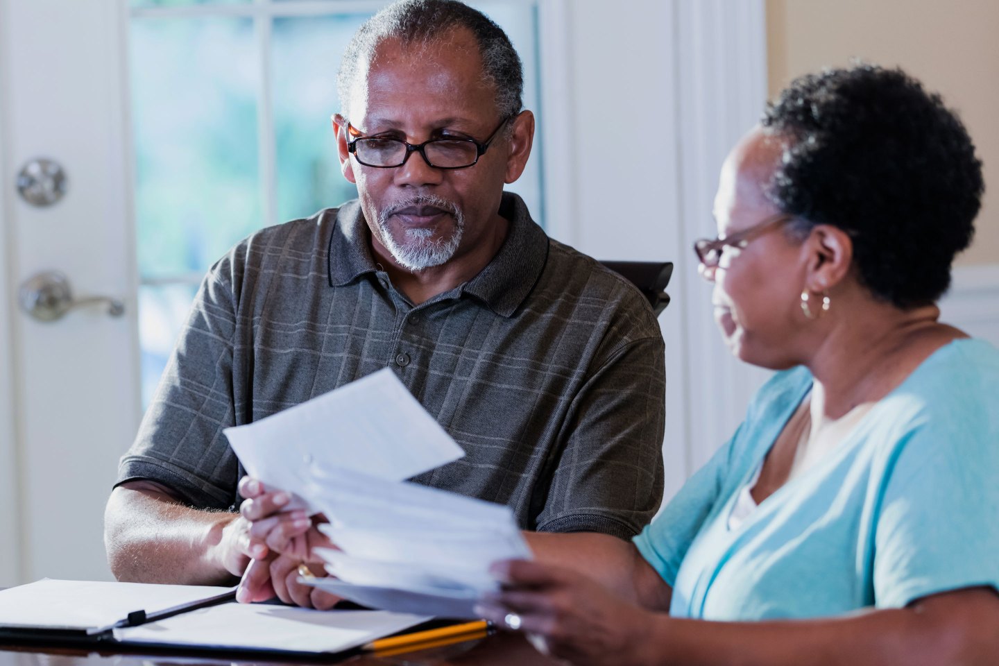 Senior couple at home paying bills