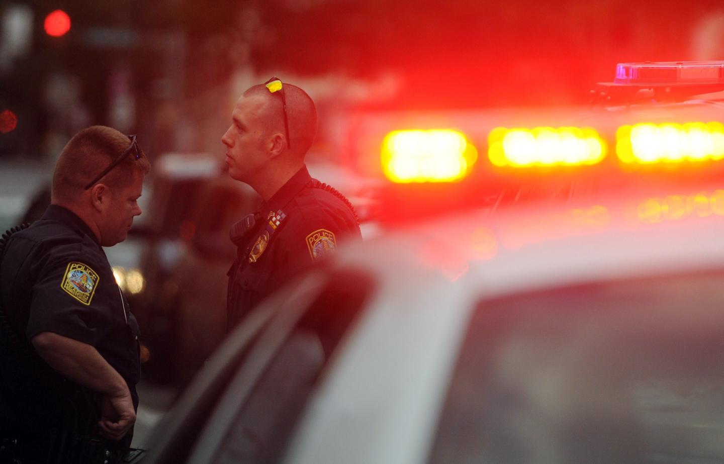 Police standing near a police car.