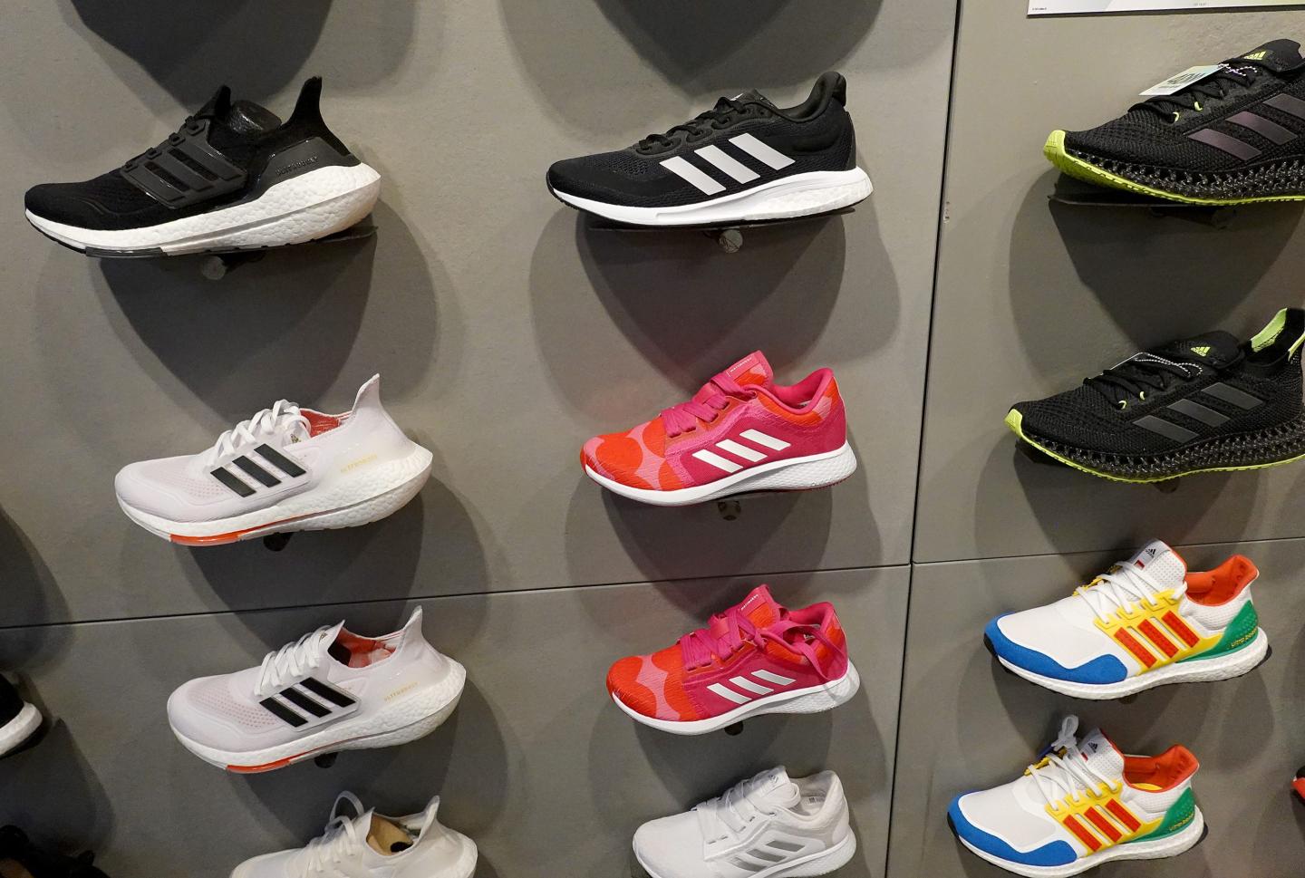 Shoes line a wall in an Adidas store on August 12, 2021 in Miami, Florida.