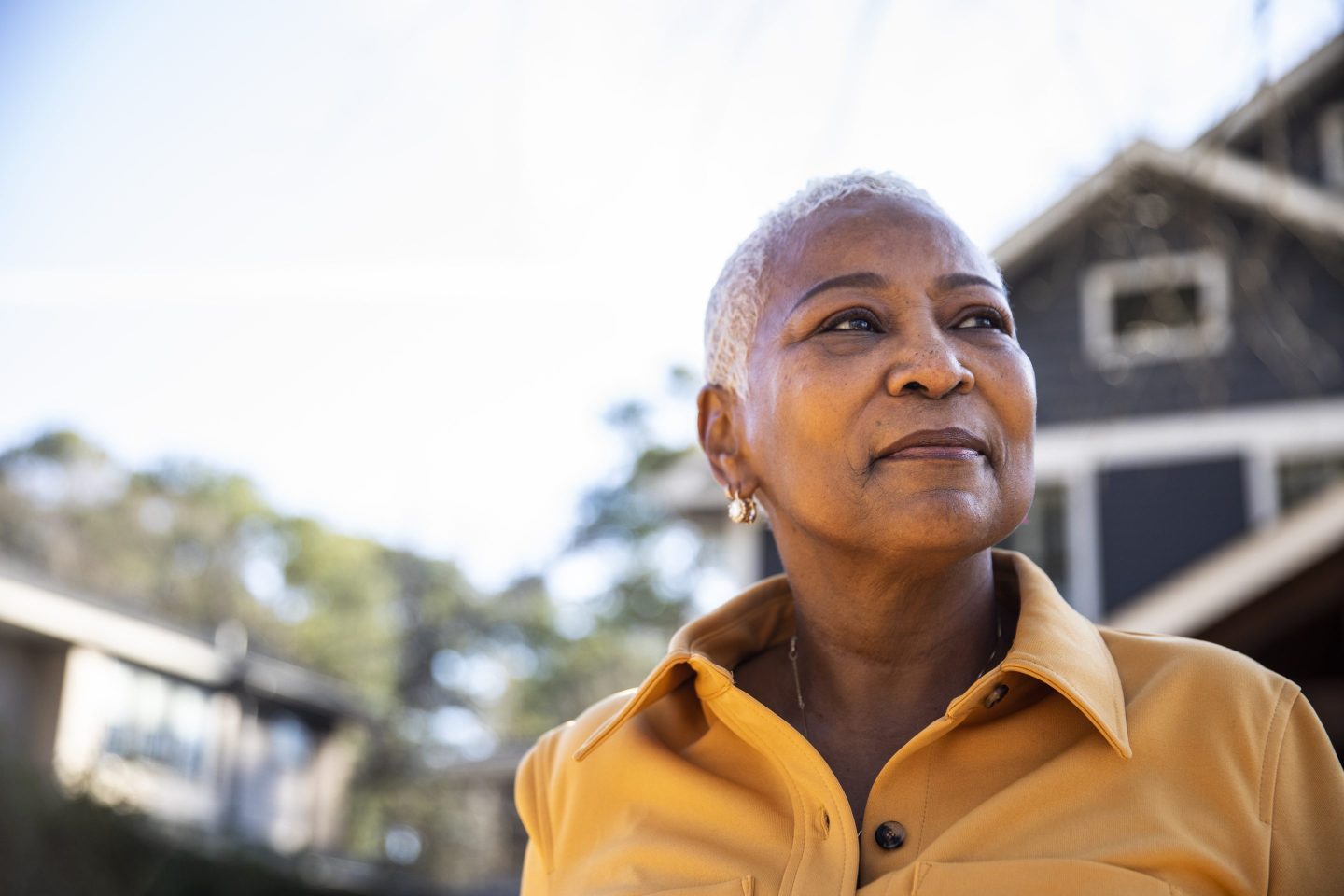 Portrait of senior woman in front of her house