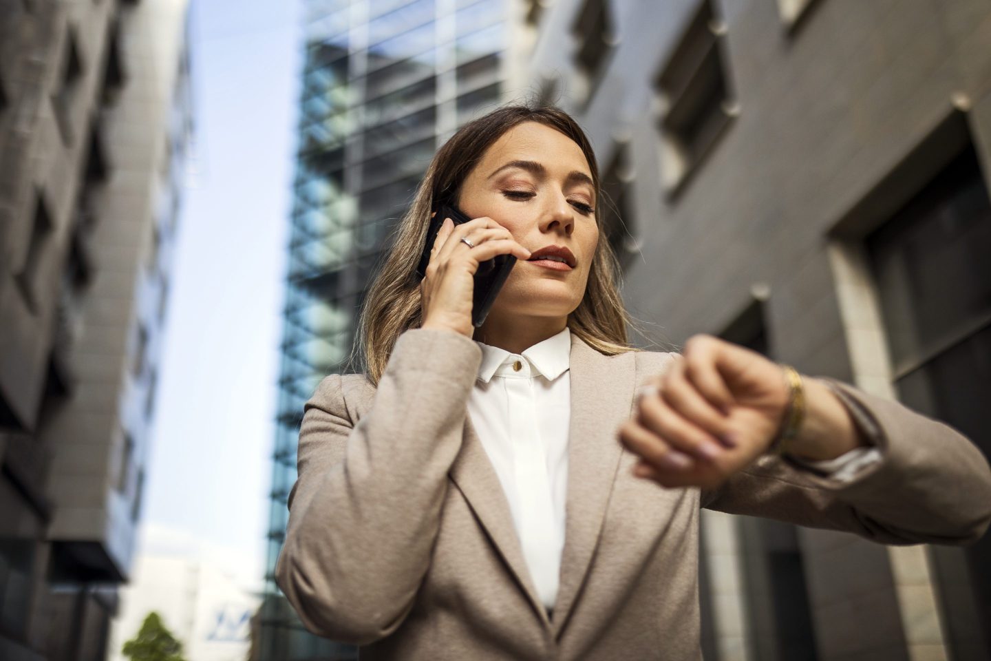 Serious looking businesswoman using phone