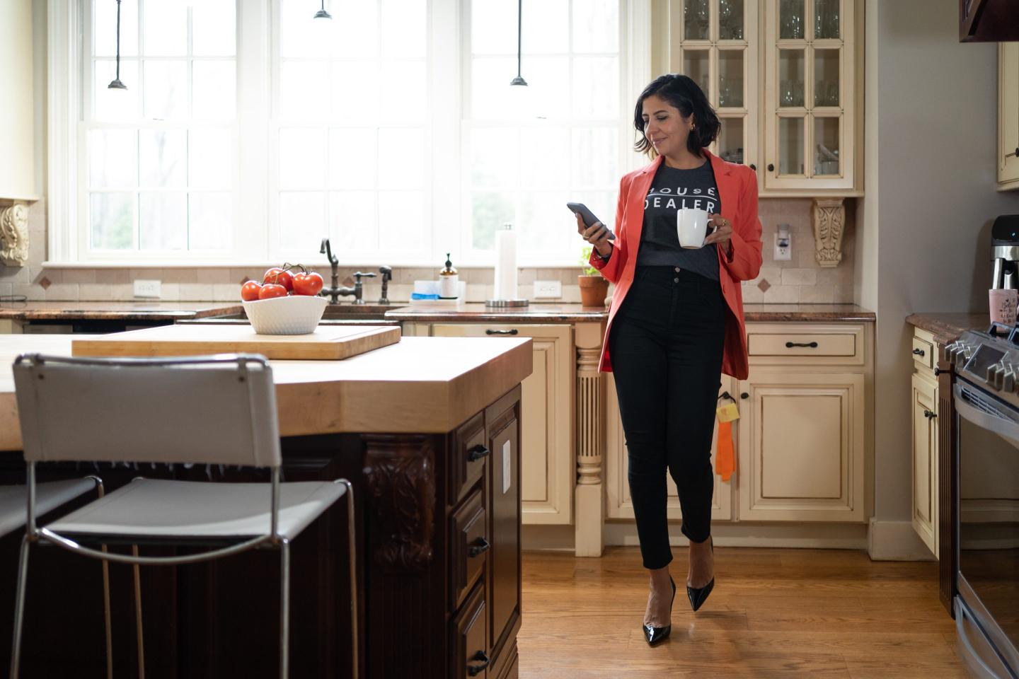 professional woman drinking coffee in her kitchen