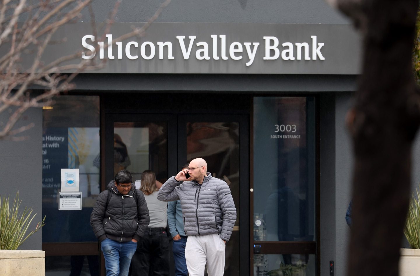Employees standing outside Silicon Valley Bank's shuttered headquarters in Santa Clara, California