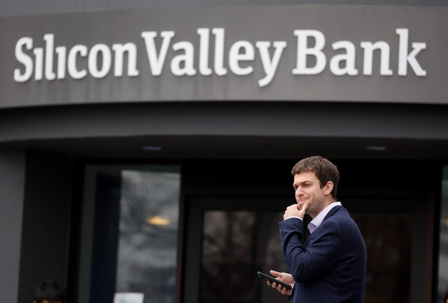 A customer stands outside the shuttered Silicon Valley Bank (SVB) headquarters on Mar. 10, 2023 in Santa Clara, California.