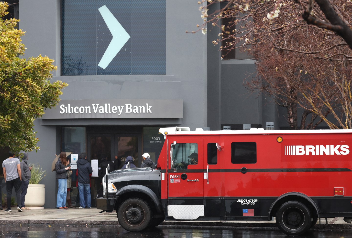 A Brinks armored truck sits parked in front of the shuttered Silicon Valley Bank (SVB) headquarters.