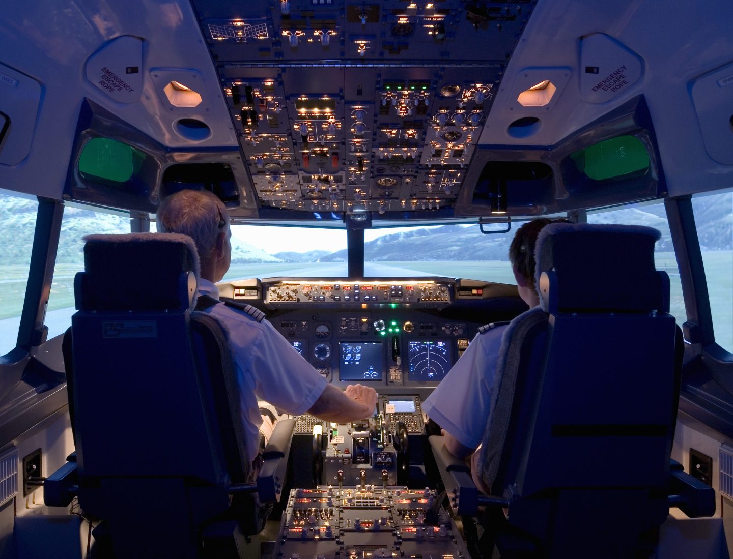 Two pilots sitting at the cockpit
