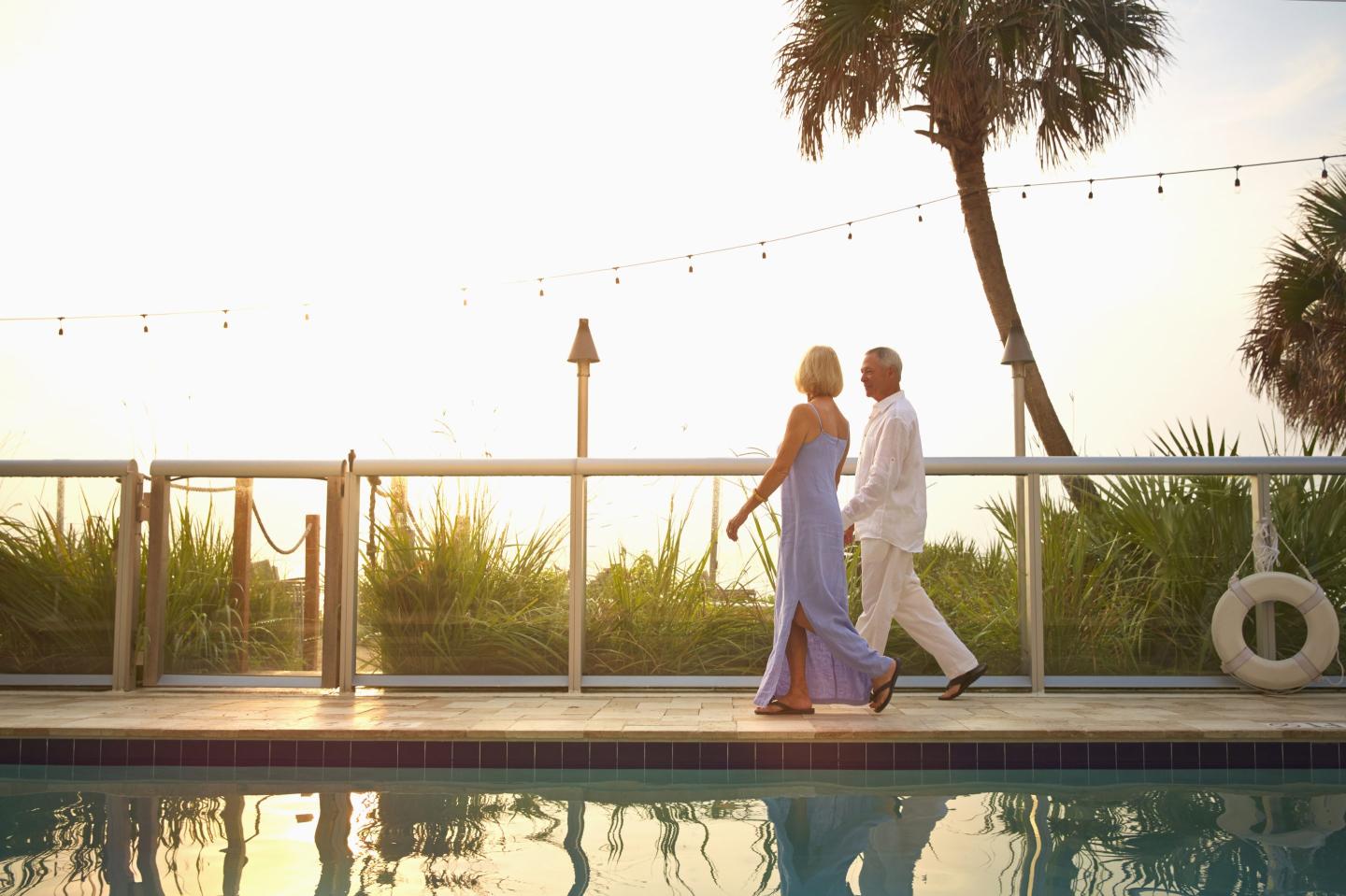 couple walking on the beach at sunset