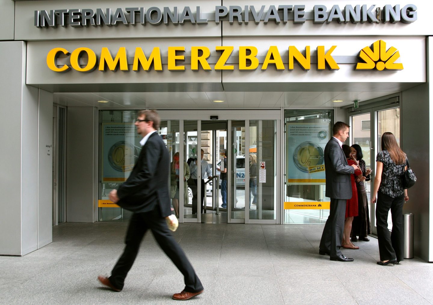 Pedestrians pass in front of the Commerzbank headquarters in Frankfurt, Germany, on Monday, Sept. 1, 2008.