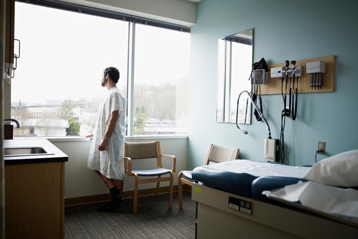 A hospital patient looking out the window in his room.