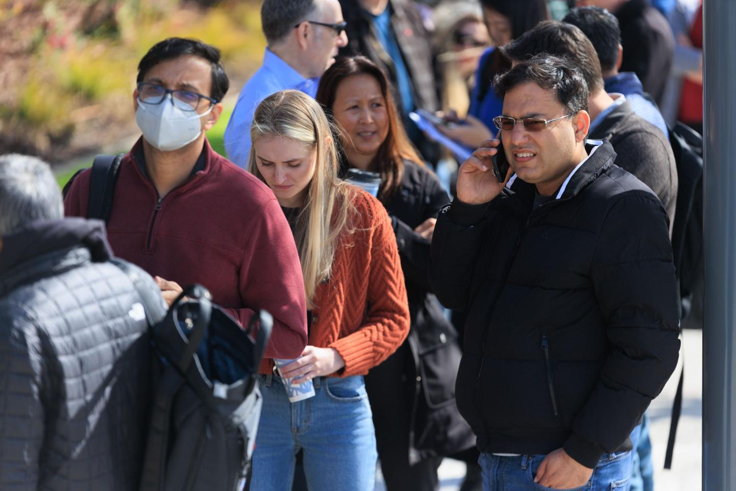 People wait outside the Silicon Valley Bank headquarters in Santa Clara, CA, to withdraw funds after the federal government intervened upon the bank collapse, on March 13, 2023.