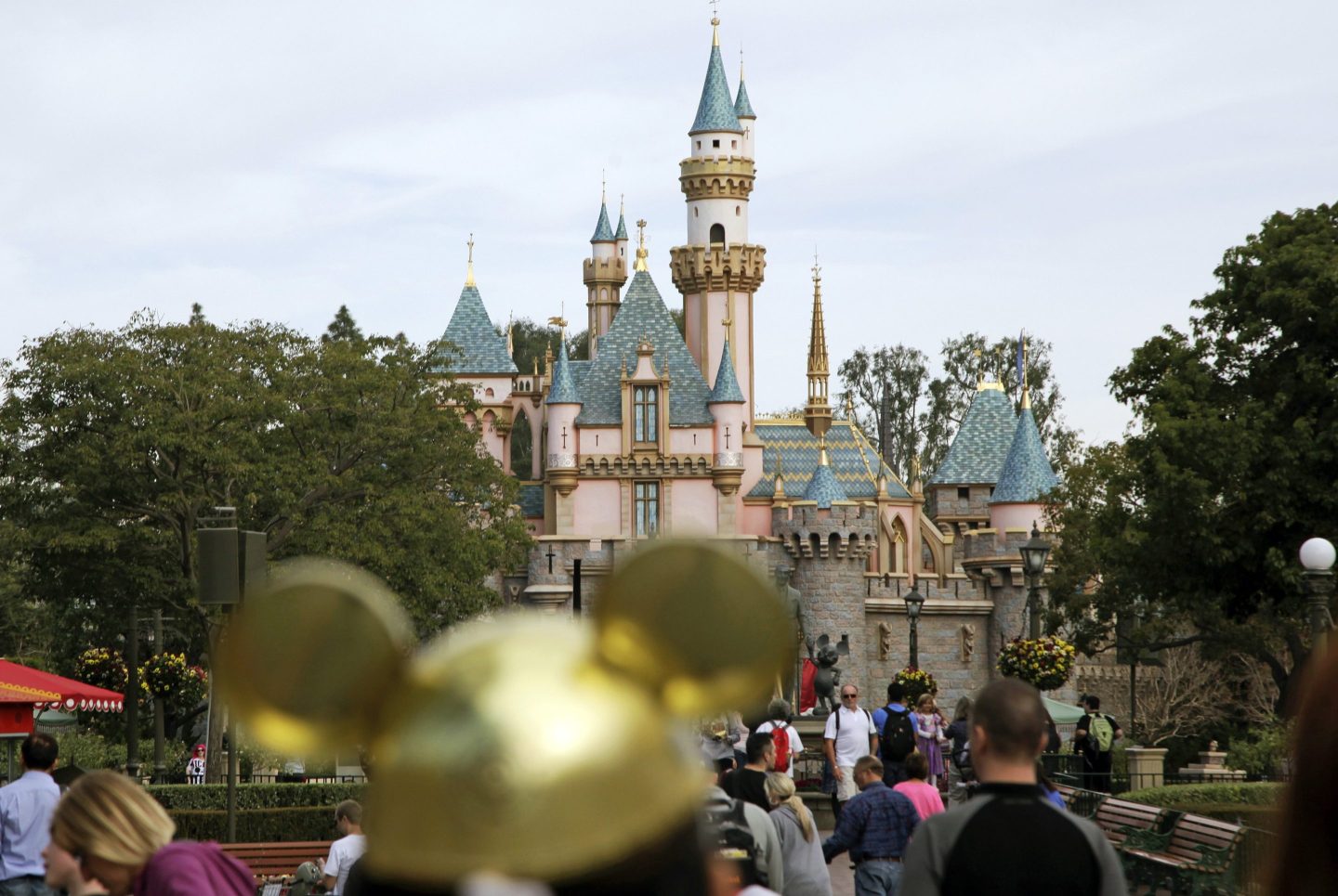 Visitors walk toward Sleeping Beauty's Castle in the background at Disneyland Resort on Jan. 22, 2015, in Anaheim, Calif.