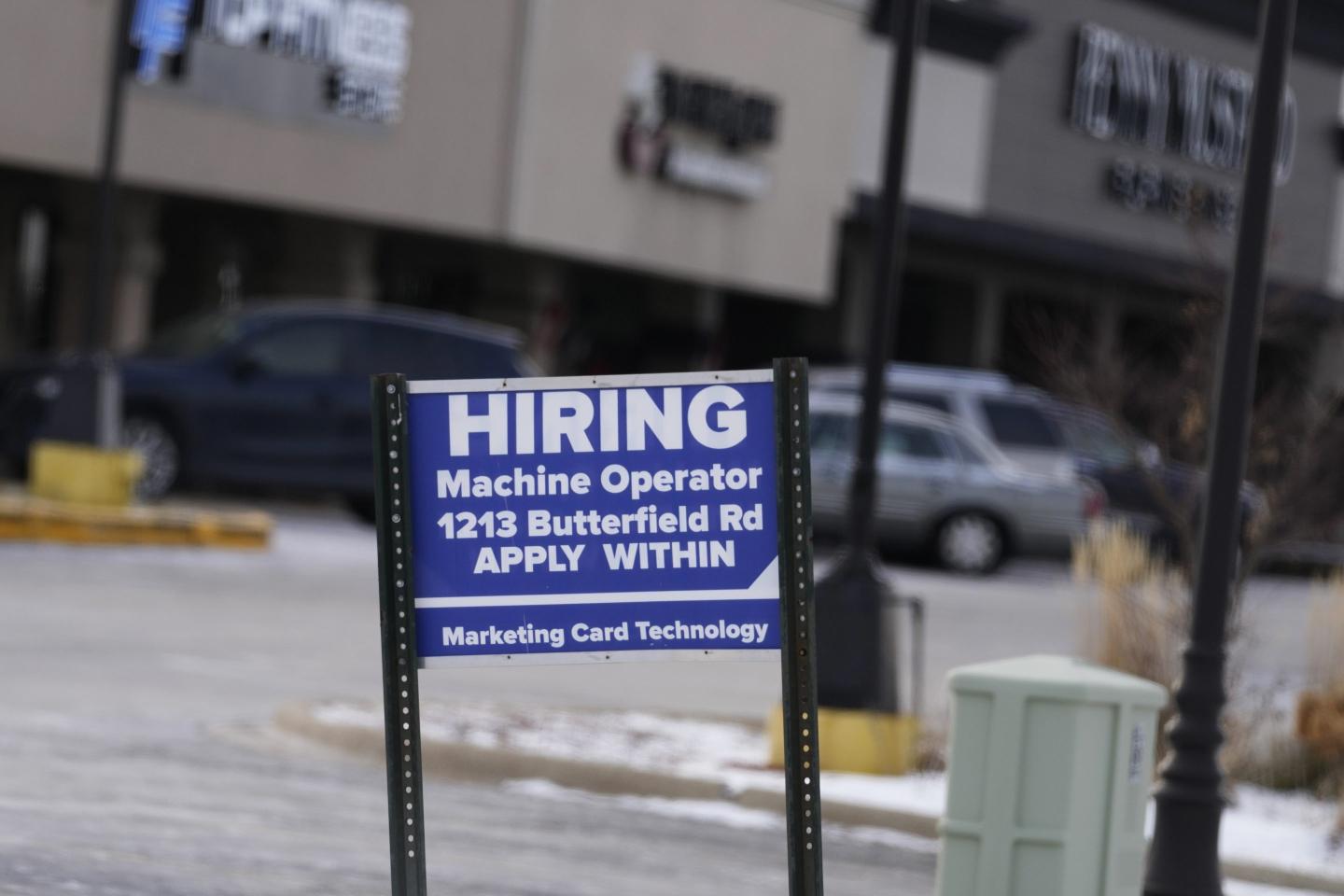 A hiring sign is seen in Downers Grove, Ill., Thursday, May 5, 2022. 