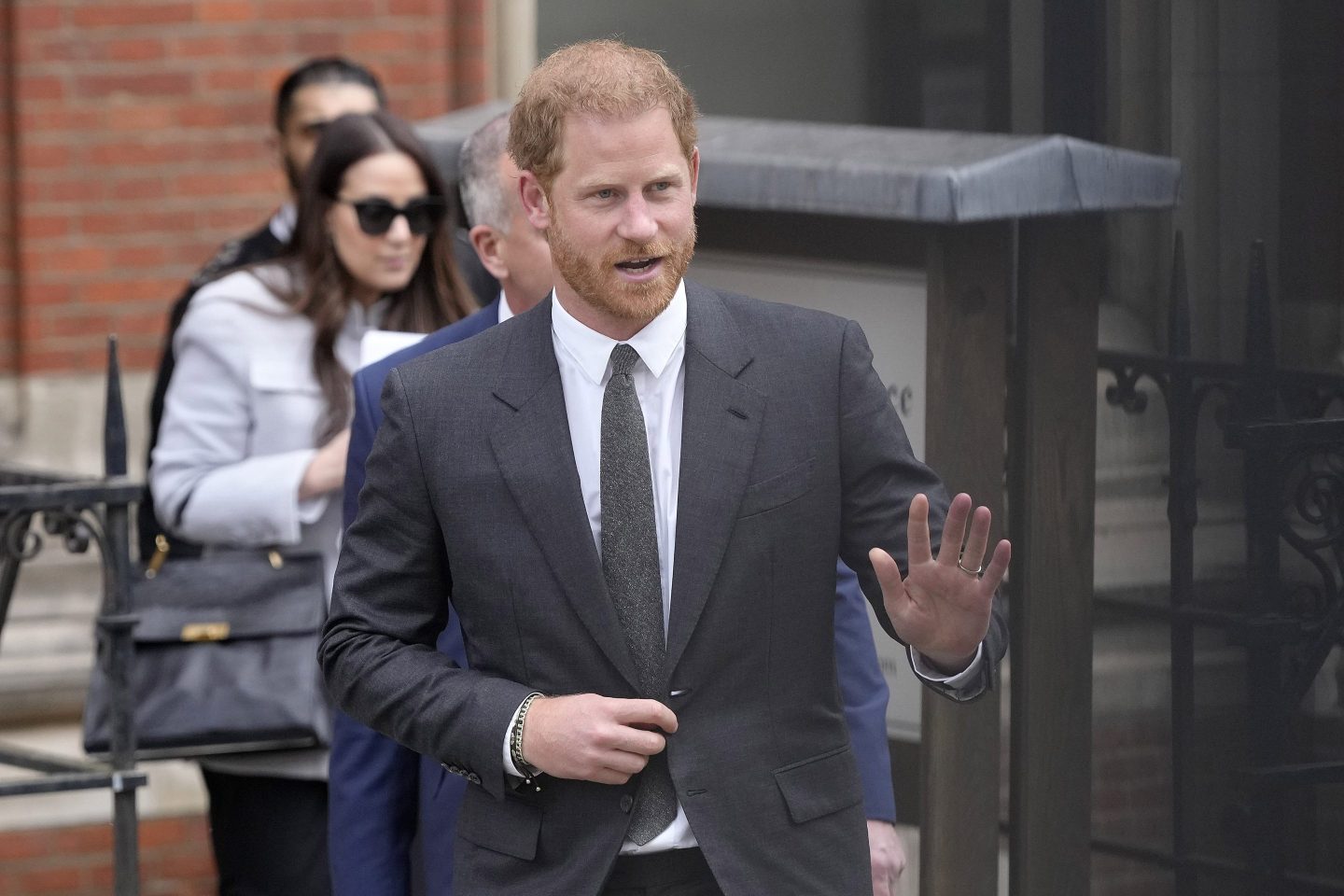 Britain's Prince Harry waves to the media as he leaves the Royal Courts Of Justice in London, Thursday, March 30, 2023.