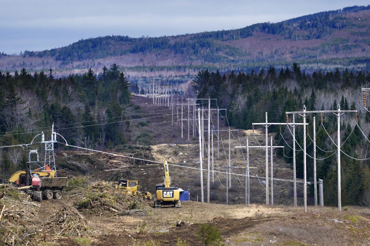 Heavy machinery is used to cut trees to widen an existing Central Maine Power power line corridor to make way for new utility poles, April 26, 2021, near Bingham, Maine.