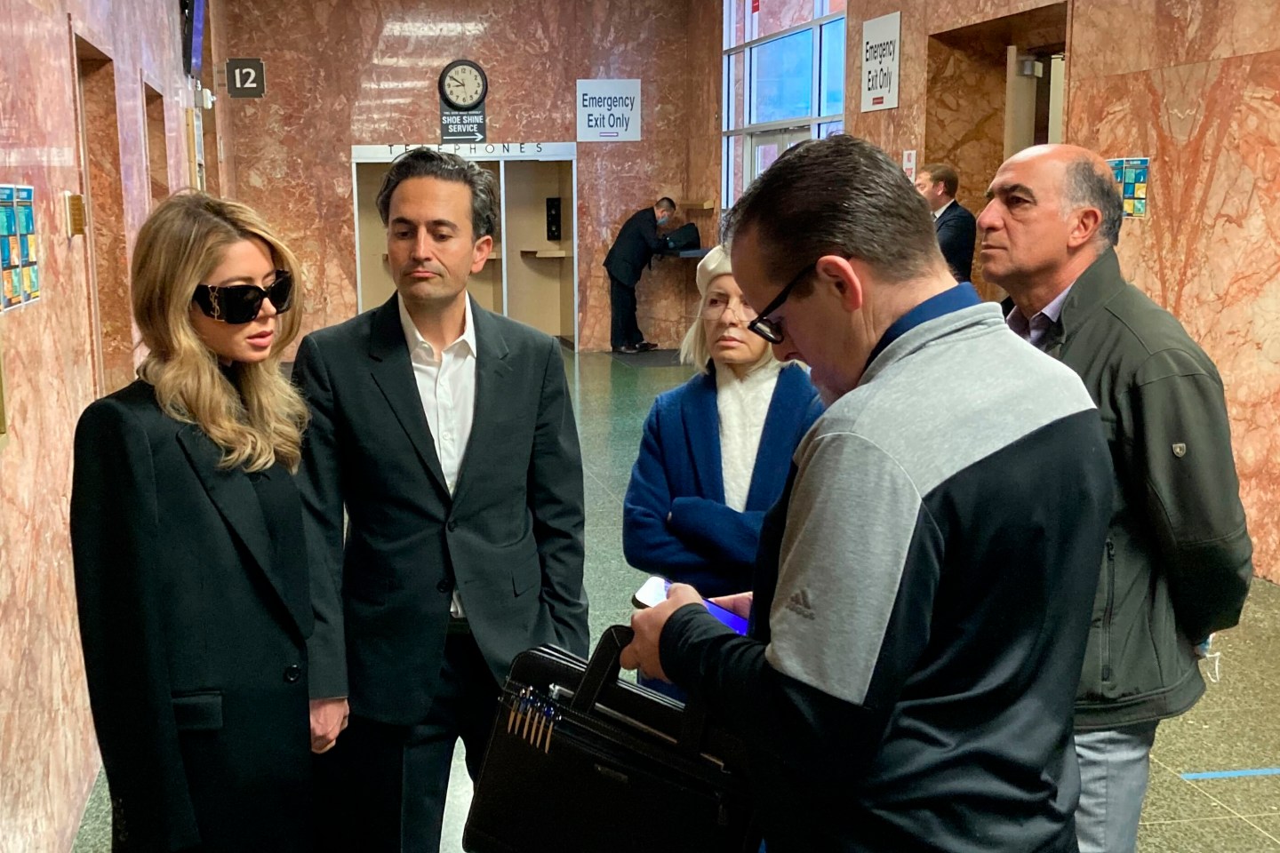 Khazar Elyassnia, left, stands in the Hall of Justice in San Francisco on Friday, April 14, 2023, ahead of an appearance by her brother, Nima Momeni, who has been charged with murder in the death of tech entrepreneur Bob Lee.