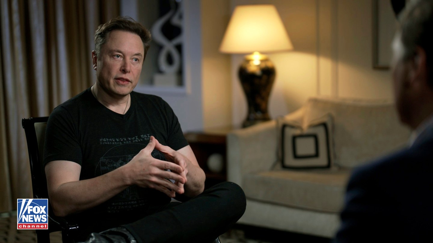 Elon Musk gestures as he is interviewed by FOX News host Tucker Carlson on April 13, 2023.