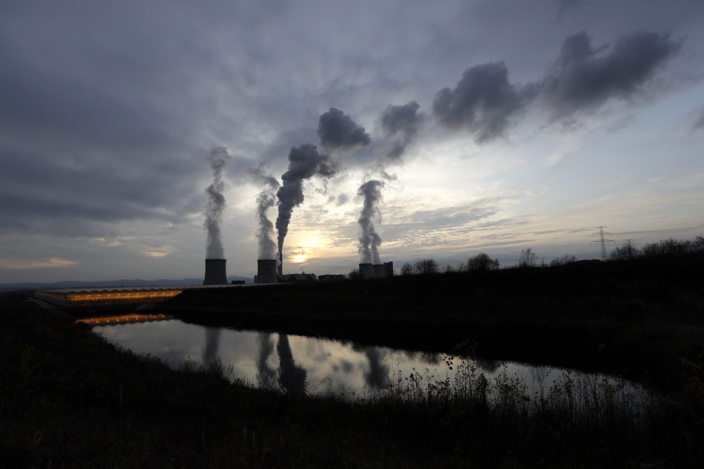 Smoke rises from chimneys of the Turow power plant located by the Turow lignite coal mine near the town of Bogatynia, Poland, on Nov. 19, 2019.