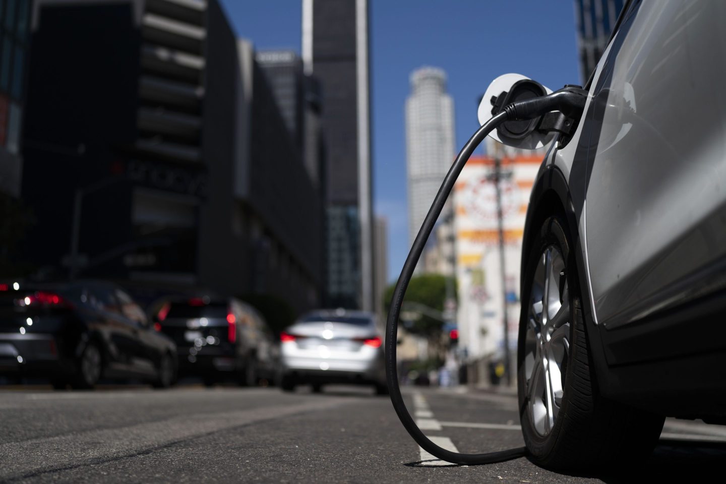An electric vehicle is plugged into a charger in Los Angeles, Aug. 25, 2022.