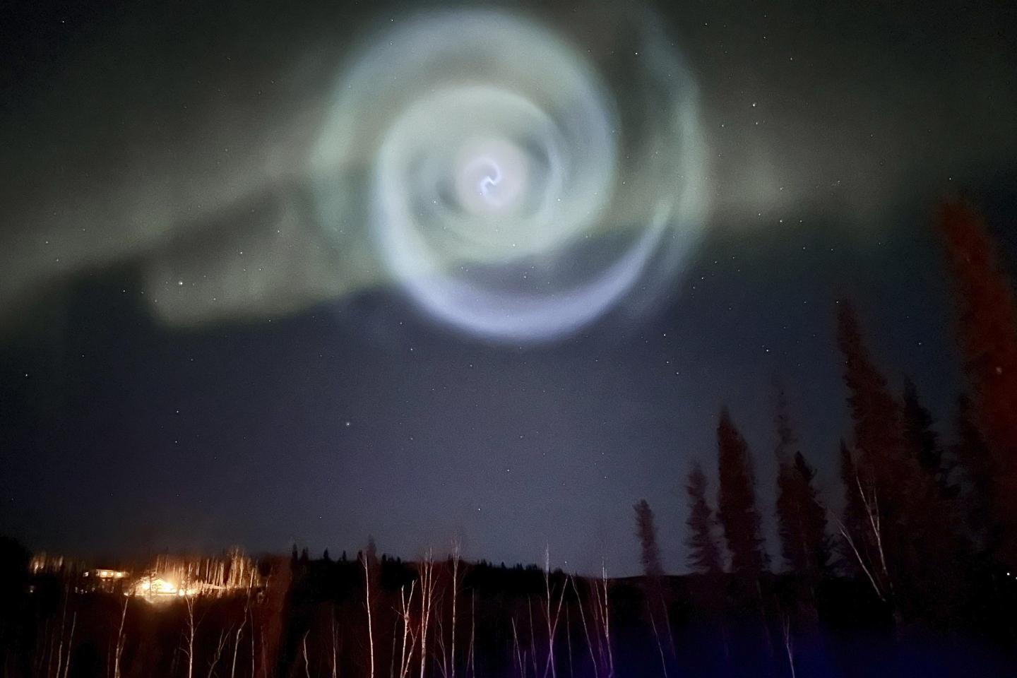 SpaceX launch leaves mysterious blue spiral amid northern lights in Alaska night sky
