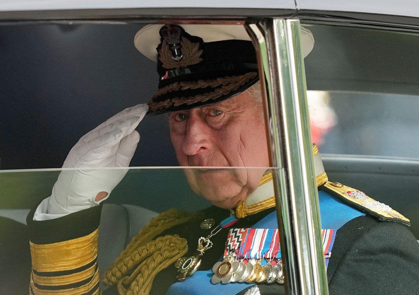 King Charles III salutes as he leaves Westminster Abbey following the state funeral service of Queen Elizabeth II in Westminster Abbey in central London, England, on Sept. 19, 2022.