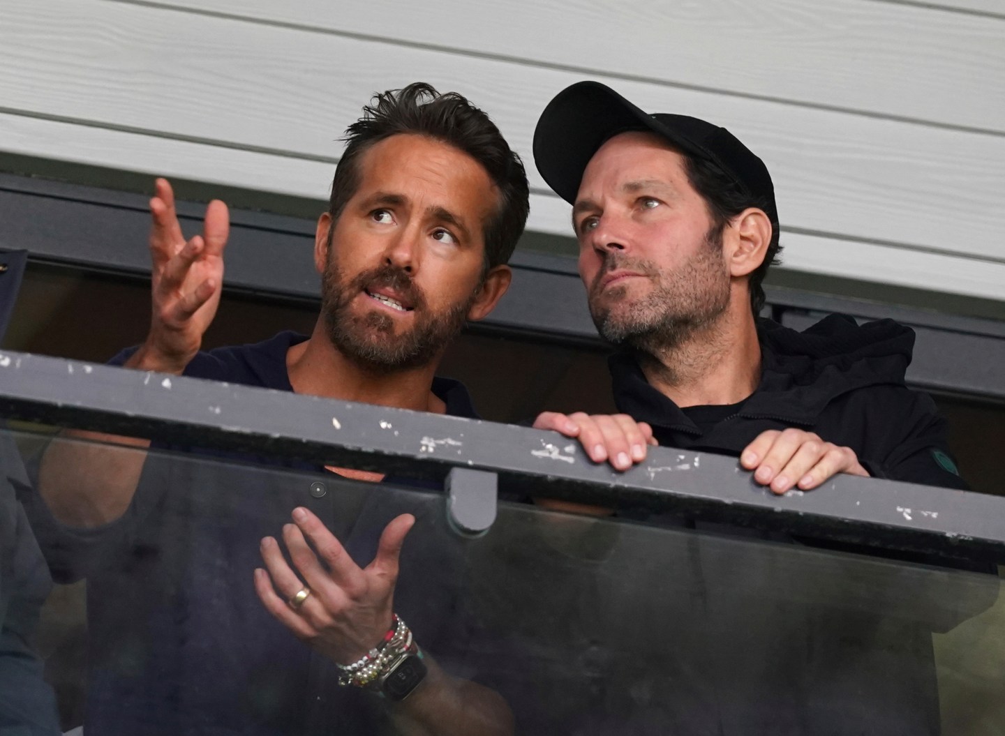 Wrexham co-owner Ryan Reynolds, left, and Paul Rudd in the stands during the National League soccer match between Wrexham and Boreham Wood at The Racecourse Ground, in Wrexham, Wales, Saturday April 22, 2023.