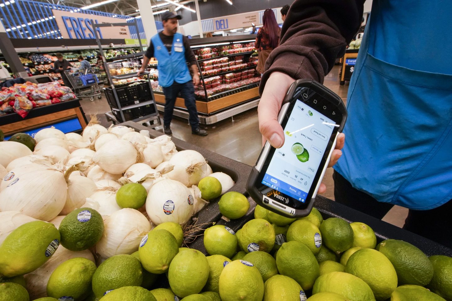 A worker scans onions, limes, and other produce inside the Walmart Supercenter in North Bergen, N.J. on Feb. 9, 2023.